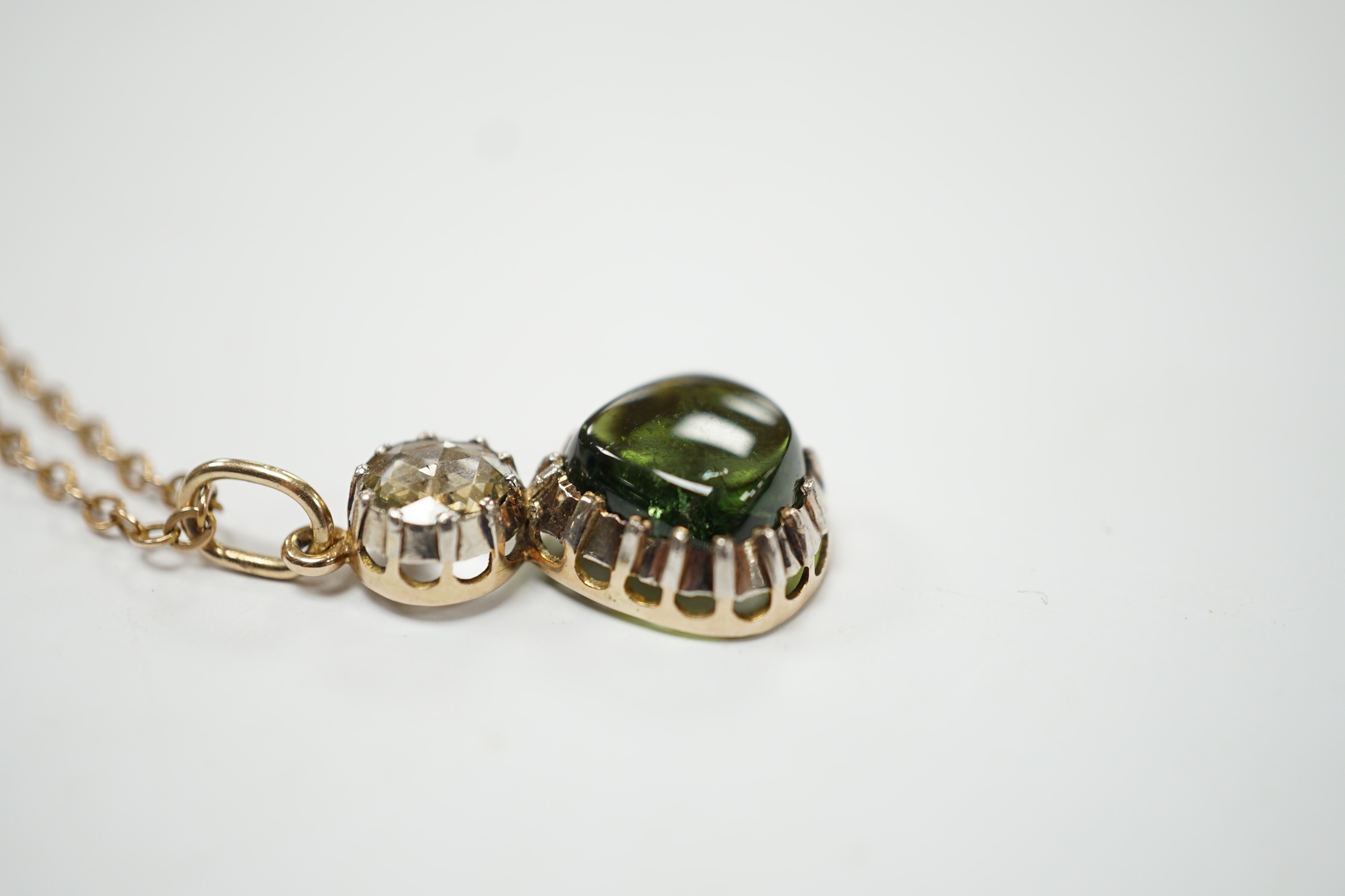 A Georgian yellow and white metal, rose cut diamond and shaped cabochon green tourmaline set pendant, 24mm, on a yellow metal chain, 48cm, gross weight 5.8 grams. Fair condition.
